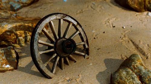 Videohive - Old Wooden Cart Wheel at Sand Beach - 32700722 - 32700722