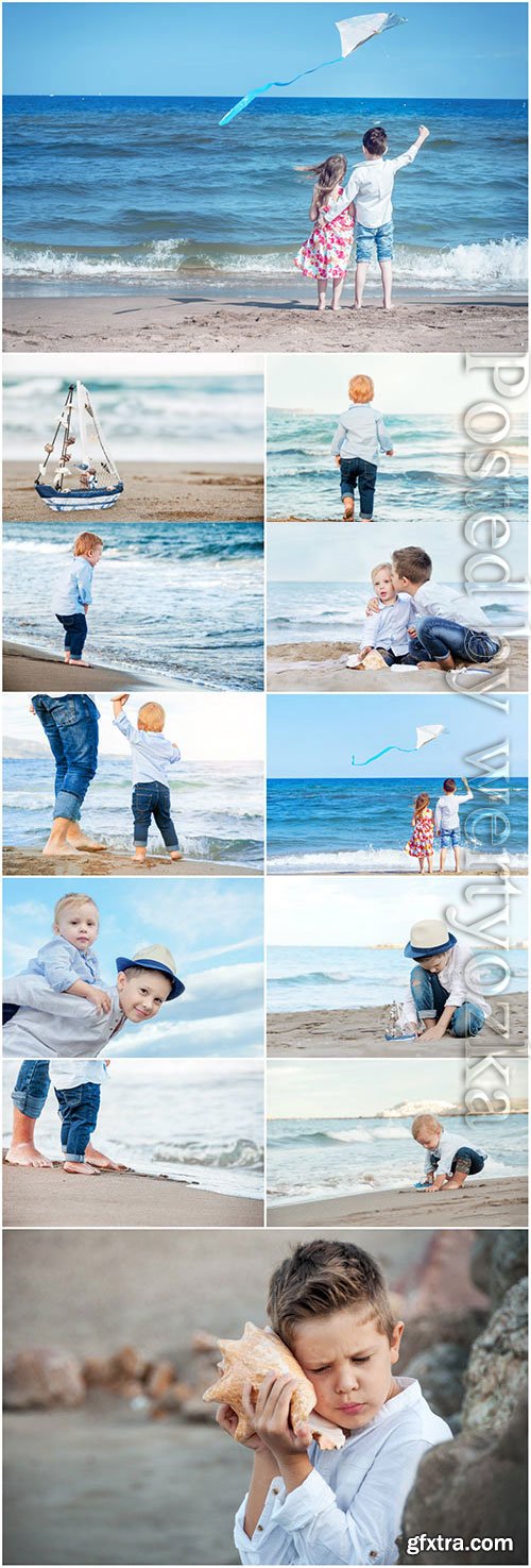 Children walking on the sea stock photo