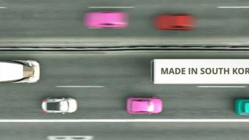 Videohive - Aerial Overhead View of Semitrailer Trucks with MADE IN SOUTH KOREA Text - 33285063 - 33285063