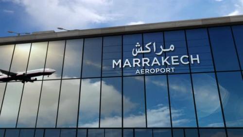 Videohive - Airplane landing at Marrakesh, Marrakech Morocco airport mirrored in terminal - 33405563 - 33405563