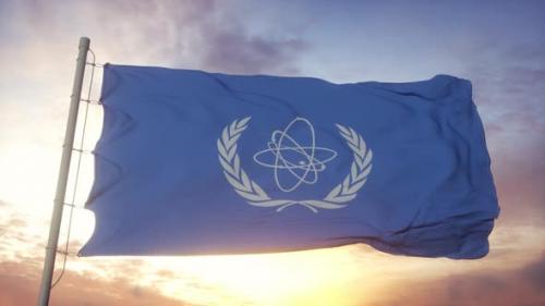 Videohive - Flag of International Atomic Energy Agency IAEA Waving in the Wind Sky and Sun Background - 33592669 - 33592669