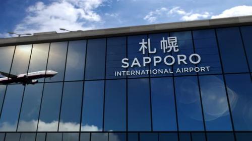 Videohive - Airplane landing at Sapporo Japan airport mirrored in terminal - 33661320 - 33661320