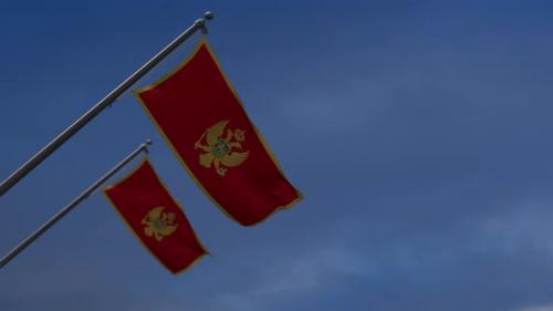 Videohive - Montenegro Flags In The Blue Sky - 4K - 34522695 - 34522695