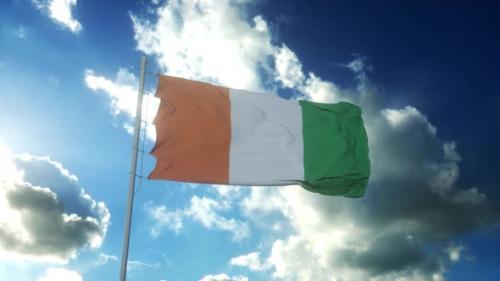 Videohive - Flag of Ivory Coast Waving at Wind Against Beautiful Blue Sky - 34943777 - 34943777