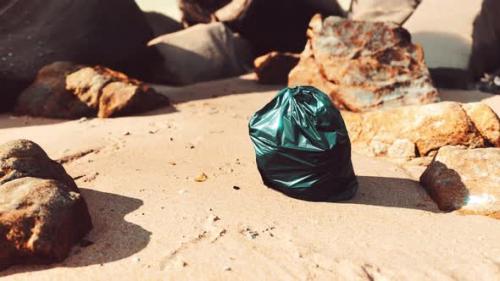 Videohive - Black Plastic Garbage Bag Full of Trash on the Beach - 35023256 - 35023256