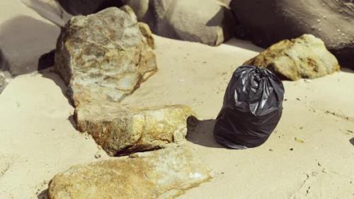 Videohive - Black Plastic Garbage Bag Full of Trash on the Beach - 35252596 - 35252596