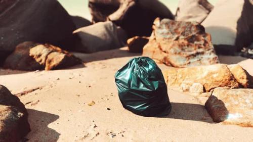 Videohive - Black Plastic Garbage Bag Full of Trash on the Beach - 35324662 - 35324662