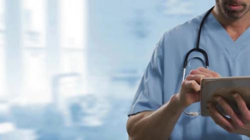 Videohive - Mid section of male health worker using digital tablet against hospital in background - 35353359 - 35353359