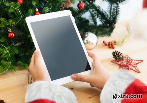 Santa Claus hands with a white tablet mockup