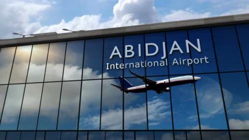 Videohive - Airplane landing at Abidjan Ivory Coast airport mirrored in terminal - 35633649 - 35633649