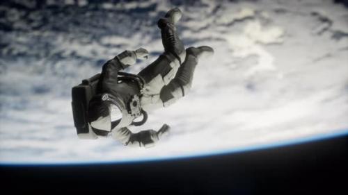Videohive - Astronaut Floating Above the Earth Elements of This Image Furnished By NASA - 36679566 - 36679566