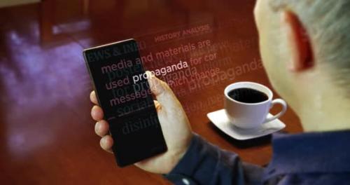 Videohive - News titles on smartphone screen in hand with propaganda - 36790441 - 36790441