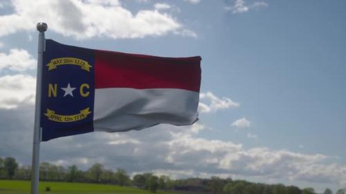 Videohive - North Carolina Flag on a Flagpole Waving in the Wind Blue Sky Background - 37901904 - 37901904