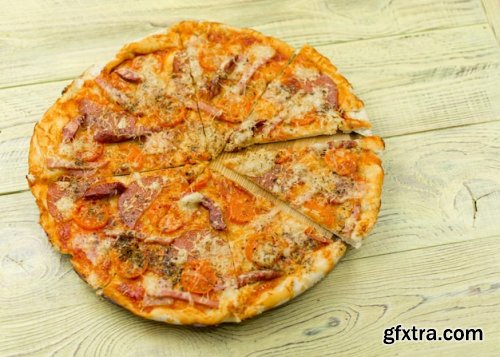 Freshly prepared homemade pizza on a wooden background