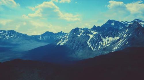 Videohive - Aerial Over Valley With Snow Capped Mountains In Distance - 38777703 - 38777703