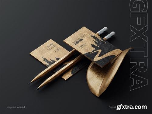 PSD wooden business card mockup scene with pencils and fancy leaf