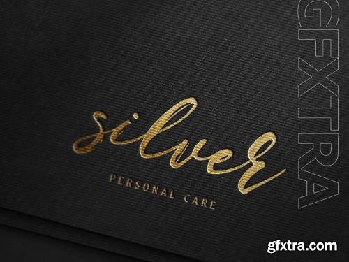 PSD luxury gold foil debossed logo mockup on textured black paper