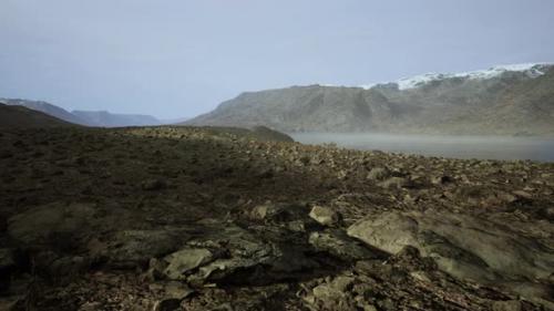 Videohive - Clear River with Rocks Leads Towards Mountains Lit By Sunset - 42557972 - 42557972