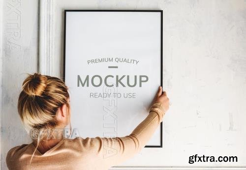 Woman Hanging a Frame Mockup 271328744