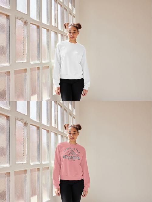 Mockup of woman wearing sweatshirt with customizable color standing by window 637252363