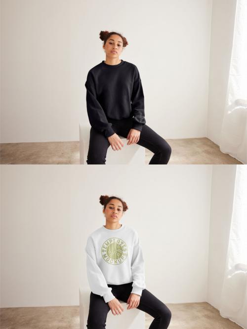 Mockup of woman wearing sweatshirt with customizable color sitting on plinth 637252321