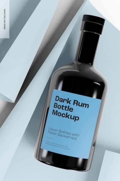 Premium PSD | Dark rum bottle with paper backdrop mockup, top view Premium PSD