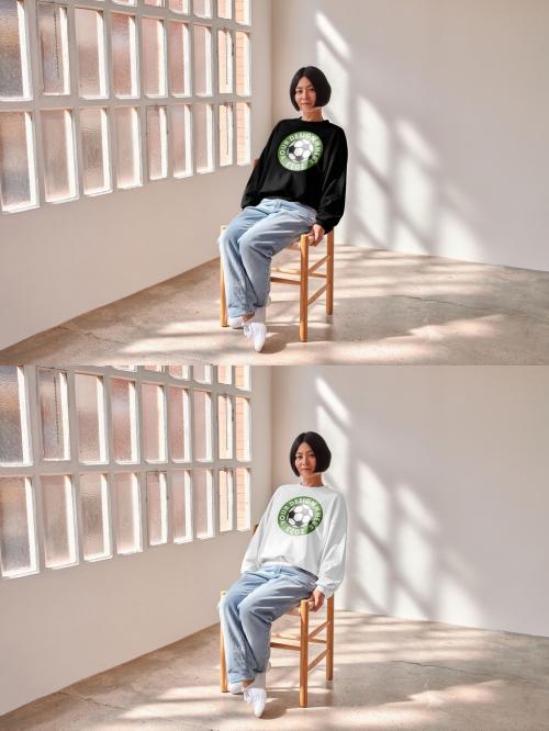 Mockup of Asian woman wearing sweatshirt with customizable color sitting on chair 640128797