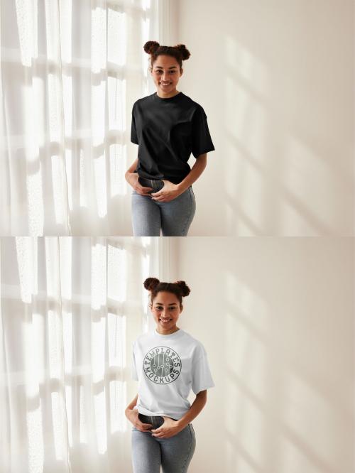 Mockup of woman wearing customizable t-shirt by window, hands on waistband 640121905