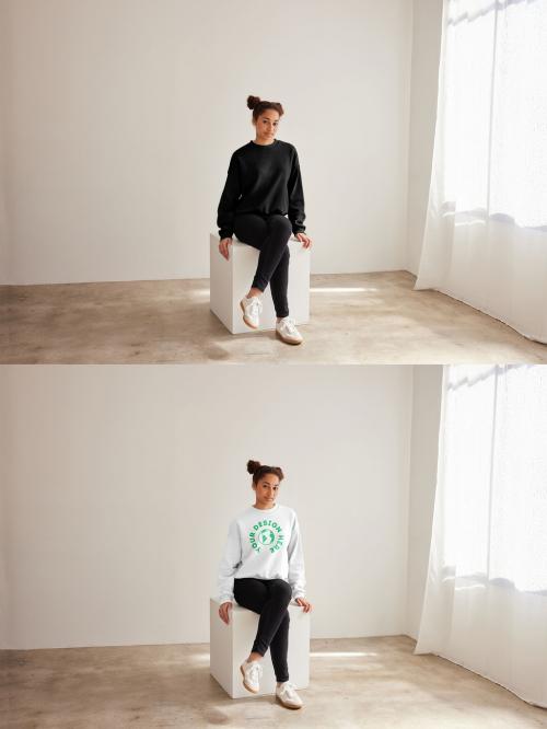 Mockup of woman wearing sweatshirt with customizable color sitting on plinth, full length 640121232