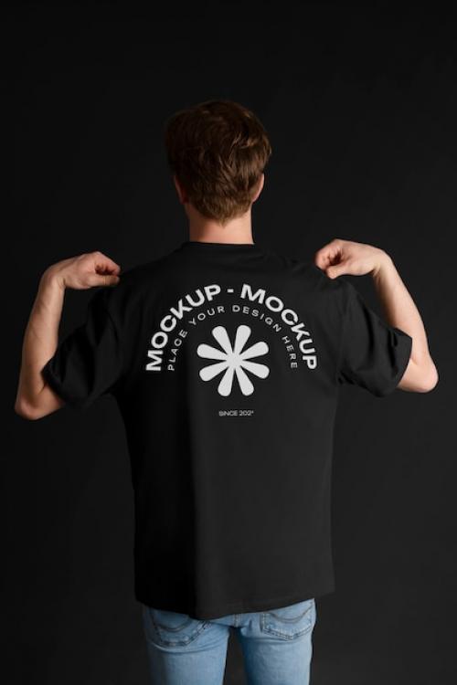 Premium PSD | Man showing back of t-shirt mock-up Premium PSD