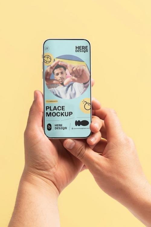 Premium PSD | Hand holding smartphone mockup Premium PSD