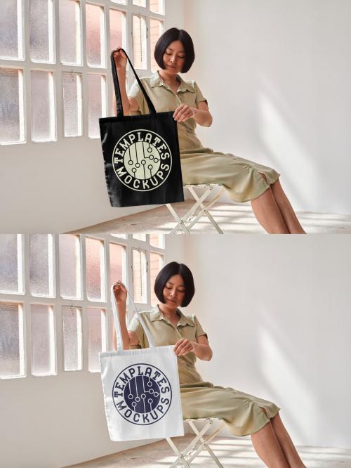 Mockup of Asian woman sitting on chair holding customizable tote bag 644106567