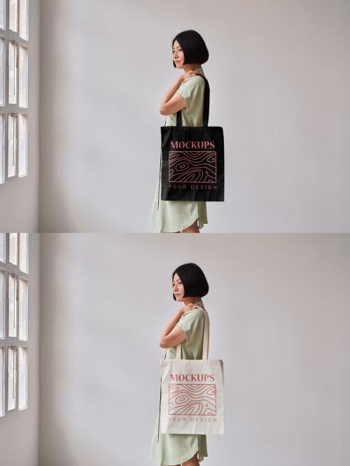 Mockup of Asian woman holding customizable tote bag, side view 644105869