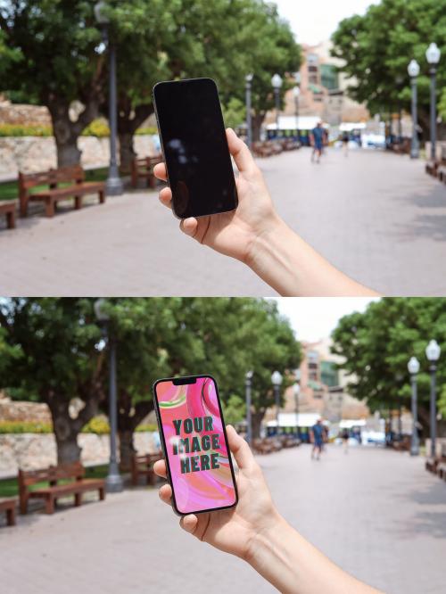 Mockup of person holding mobile phone with customizable screen in city scene 649152053