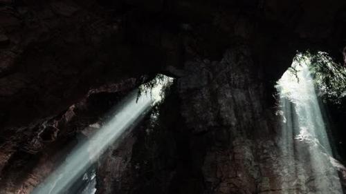 Videohive - Sunlight Streaming Into a Mysterious Cave Creating a Volume of Light - 48094394 - 48094394