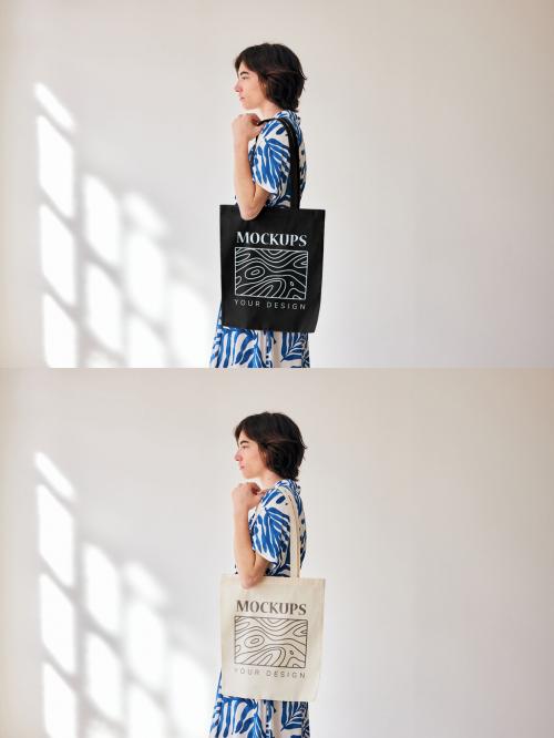 Mockup of woman holding customizable tote bag by wall, side view 646711145