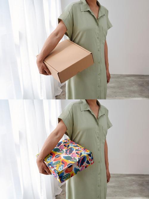 Mockup of Asian woman holding customizable gift box under arm 646709931