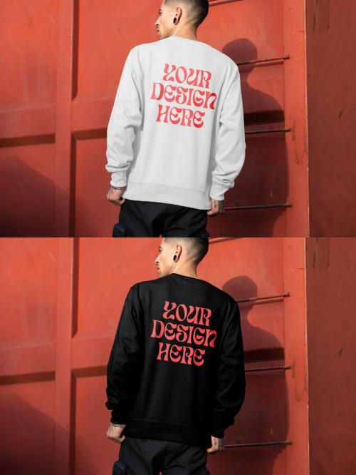 Mockup of man wearing sweatshirt with customizable color by urban building, rear view 646704647