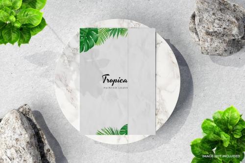 Premium PSD | Textured paper poster mockup with marble rocks and plants Premium PSD