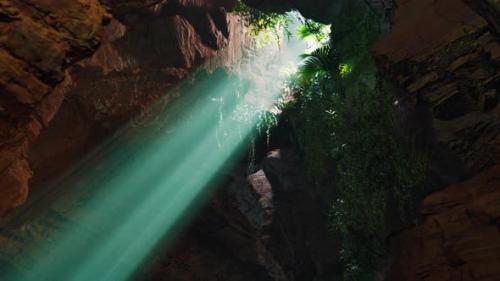 Videohive - A Mesmerizing Green Light Shining Through the Entrance of a Mystical Cave - 48388532 - 48388532
