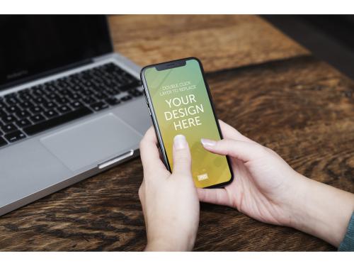 Smartphone Held Above Wooden Table Mockup - 198379266