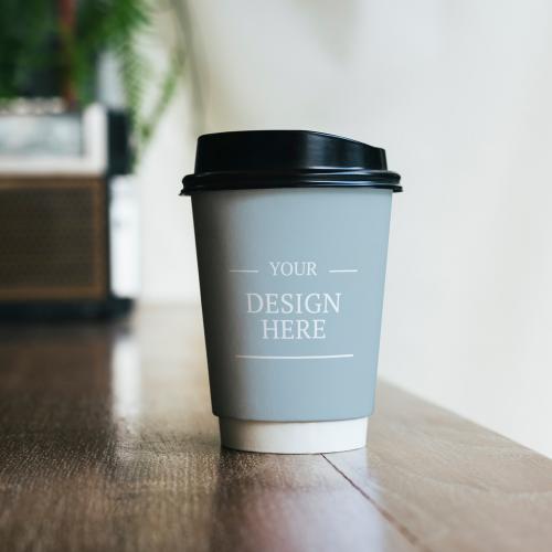 Paper Coffee Cup on Table Mockup - 249379969