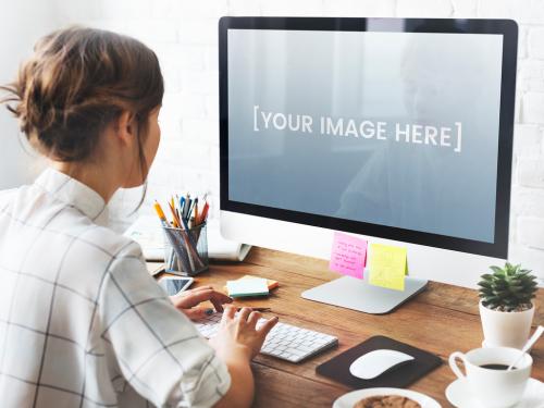 Desktop Computer User at Desk Mockup - 253411265