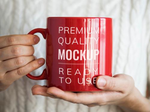 Person Holding Red Mug Mockup - 260604682