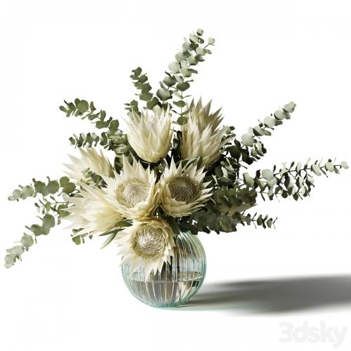 Bouquet with white proteas and eucalyptus in a ribbed glass vase