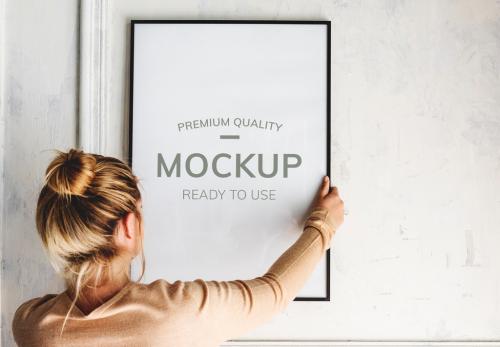 Woman Hanging a Frame Mockup - 271328744