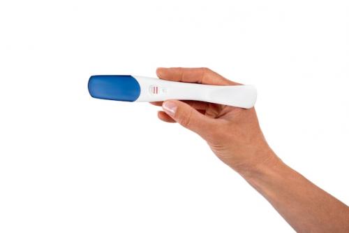 Hand Holding Positive Pregnancy Test