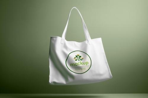 Mockup Of A White Tote Bag Logo On A Green Background