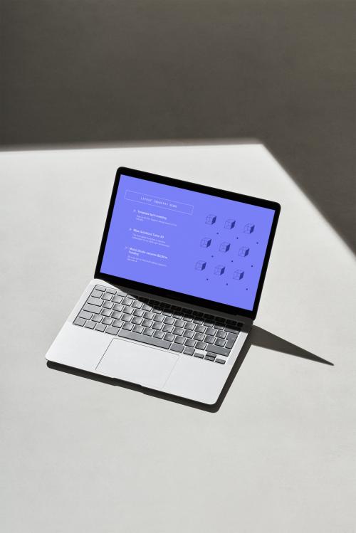 Laptop on a Grey Surface with Hard Shadows - 478873544