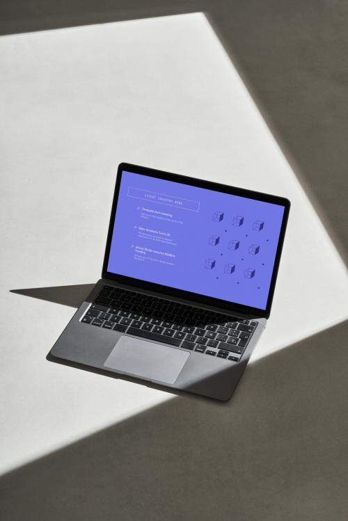 Laptop on a Concrete Surface with Sun Light - 478873547